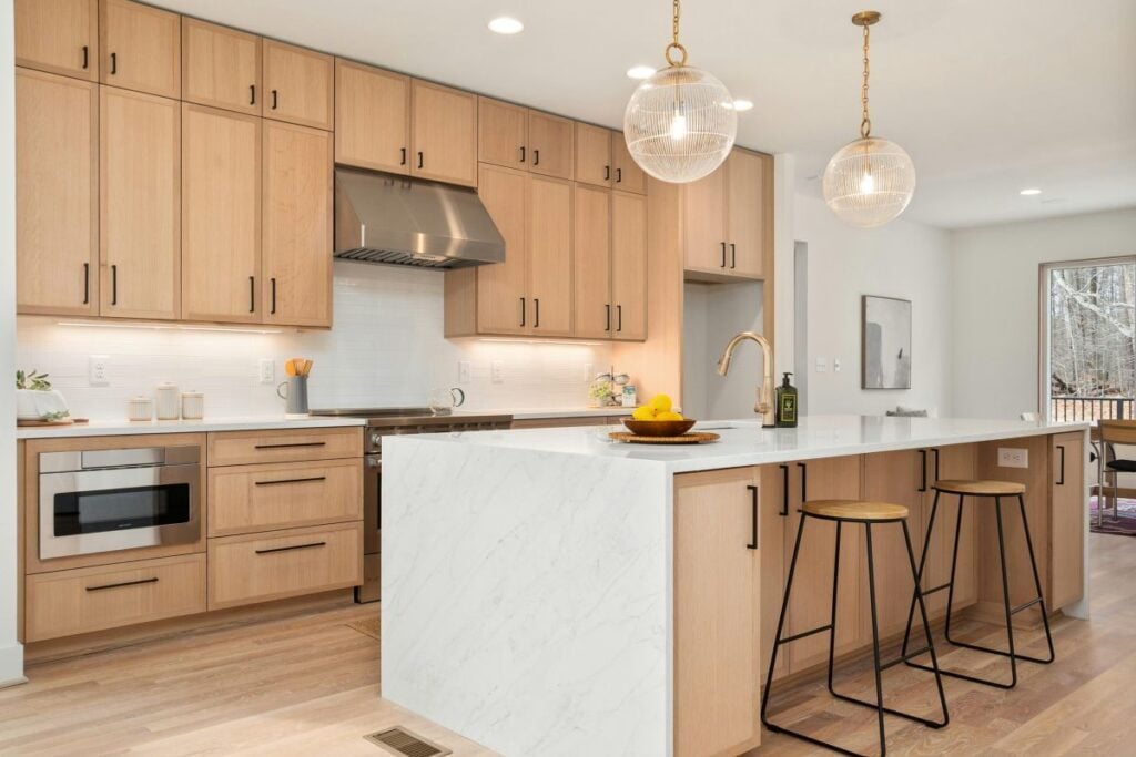 Kitchen remodel with white oak cabinetry and waterfall island